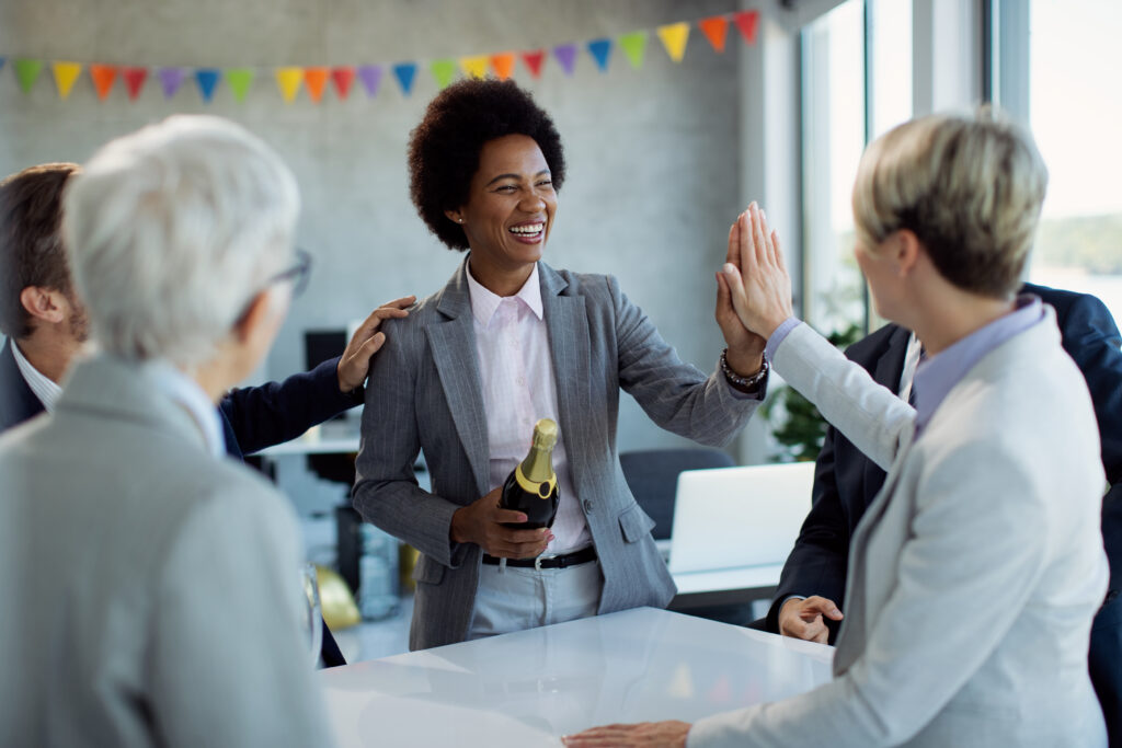 Sales team celebrating a member’s promotion